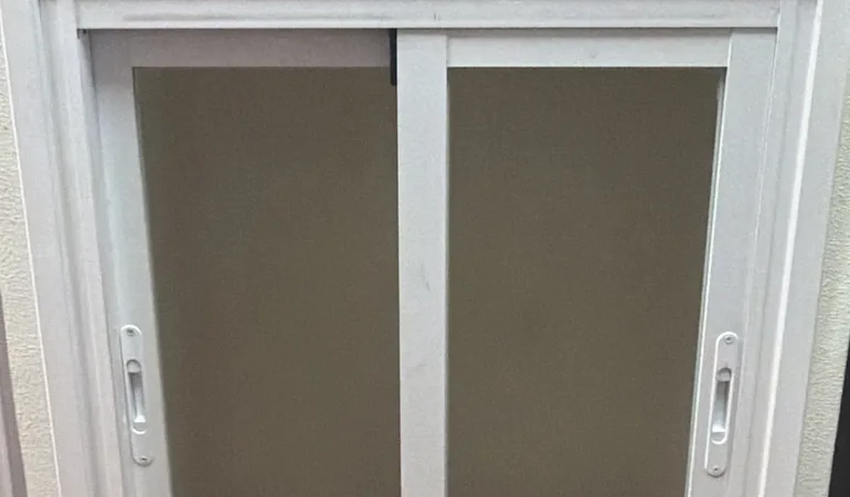 Ventana corredera de aluminio con sus manillas de cierre